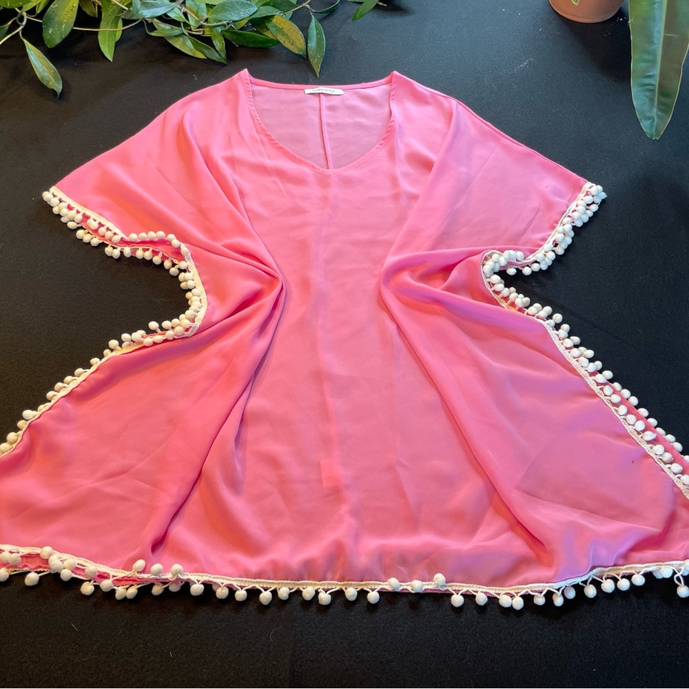 Pink bathing suit, cover-up with white trim.  V-neck.